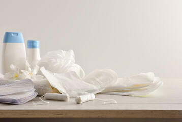 Fototapeta na wymiar Menstrual hygiene products and toiletries on table white isolated background