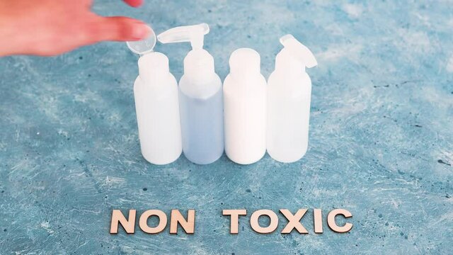 low tox and natural beauty products, group of lotion bottles with non-toxic text on blue background