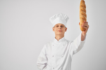 a man in chef's clothes with a baguette in the hands of a gourmet restaurants