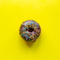 one chocolate doughnut in solid background top view