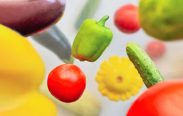 Vegetables levitating in the air pepper, cucumber, zucchini, eggplant and tomato on a white background