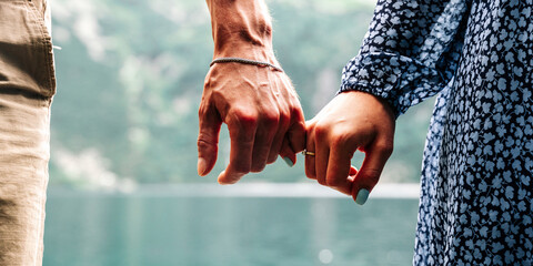 Couple walking. Happy young romantic people holding hands. Love couple man and woman together in summer park. Young family traveling active adventure vacations.