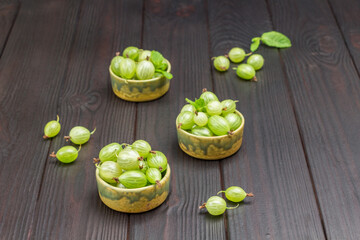 Green bowls with green gooseberries.
