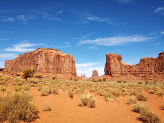 Fototapeta premium Monument Valley on a background of blue sky with clouds USA