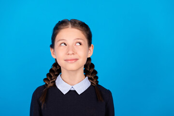 Photo of young pretty good mood peaceful girl look copyspace dreaming thinking isolated on blue color background