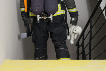 fireman holding plush toy, back view