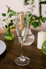 Elegant stylish decor of a festive table or interior. Dried flower in a glass of champagne