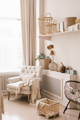 Young parents ' bedroom in beige shades: a feeding chair, a cradle and a Scandinavian-style decor