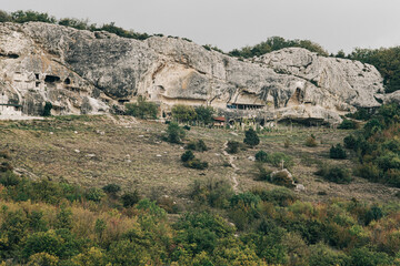 Autumn landscape of ancient cave town in a rocky ridge.
