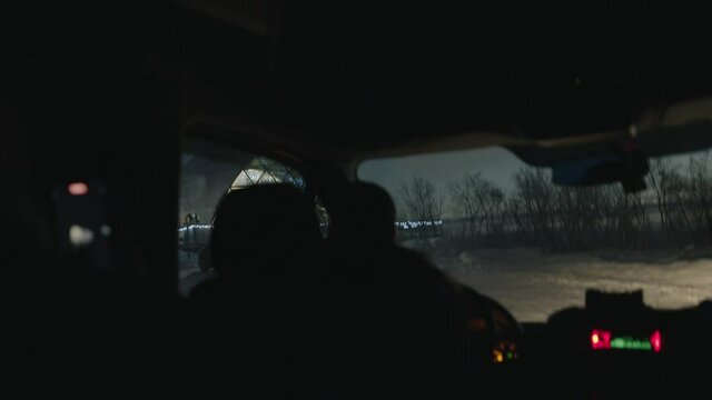 View from the car cabin on the igloo glass domed houses glowing in the evening with illumination