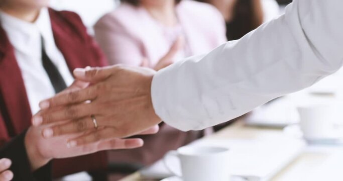 Businesspeople walking through into office passed row of businesswomen sitting clapping hands and do high-five touch hand palm with everyone. Idea for happy emotion with success and beloved teamwork.