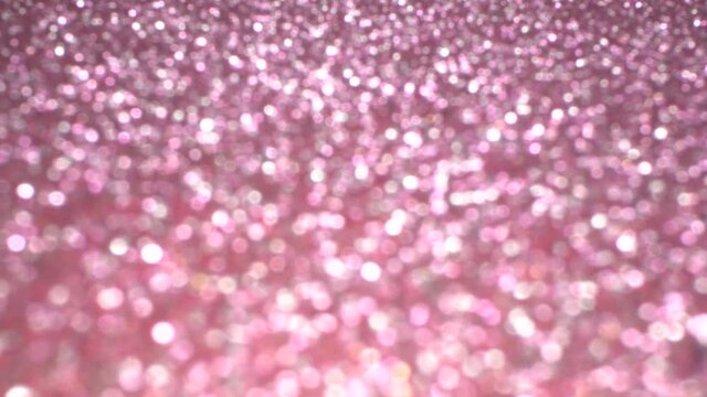 Pink glitter festive texture. Brilliant background for holiday. A beautiful magic bokeh
