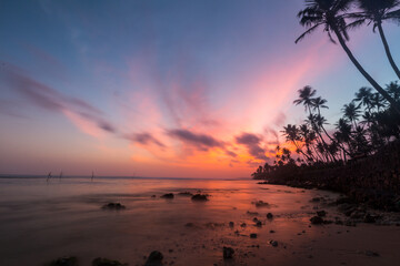Naklejka na ściany i meble beautiful sunset over a deserted beach
