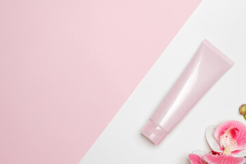 Cosmetic face mask on a light background with an orchid.