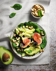 Salad with figs, avocado, spinach and cashews. Dressing from balsamic sauce. Food styling of a...