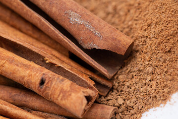 Close-up photo of cinnamon sticks and powder. Seasoning food with cinnamon