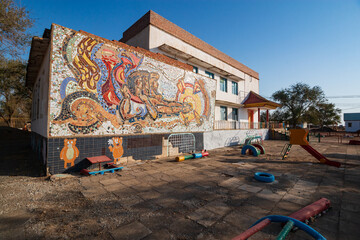 Old kindergarten building with mosaics on the wall