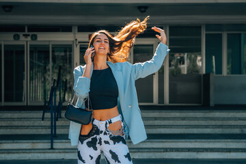 young woman or girl on the street with mobile phone