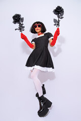 Demonic gothic brunette posing in white studio. Role-playing games, halloween, party shop...