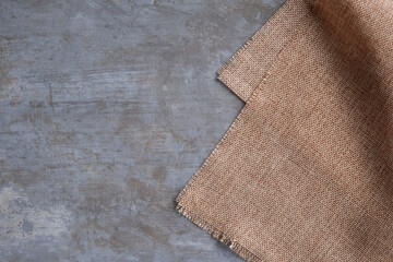 Background of sackcloth laid on a polished cement surface.