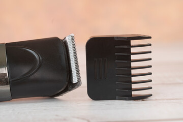 Cordless hair trimmer. During the pandemic when barbershops are closed, more men bought the devise to cut their own hair. Selective focus points. Blurred background