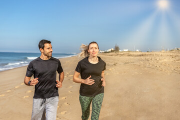 A fitness trainer and a client, a European woman, shake hands. Happy and contented. Against the background of the sea in summer.