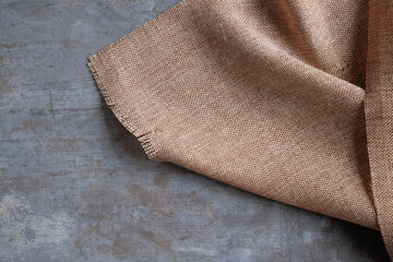 Background of sackcloth laid on a polished cement surface.