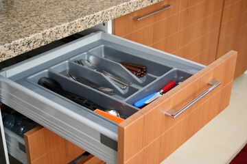Forks, spoons, knives in the sliding drawer. Sliding kitchen drawers.