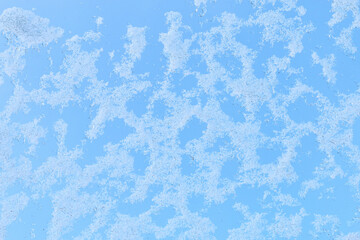 Fototapeta na wymiar Melting snow on the glass - abstract winter background.