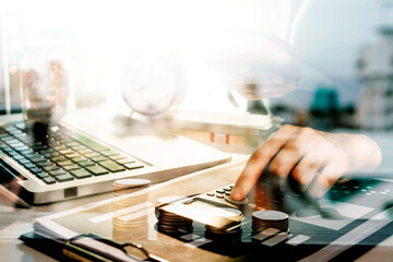 businessman holding coins putting in glass and using calculator. concept saving money and finance accounting.