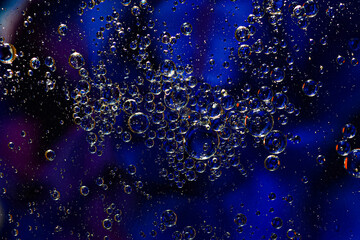 Naklejka na ściany i meble Photo of oil on a water surface with bubbles. Abstract colorful background. Macro close-up, not illustration