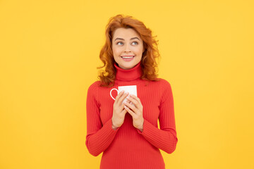 charming redhead woman face portrait drink coffee from cup on yellow background, morning