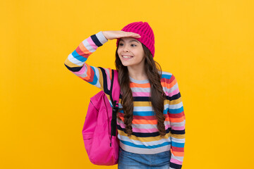 happy teen girl with backpack looking for something. back to school. hipster kid with school bag.