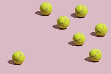 Many Tennis balls on pink background. No ordinary pattern background image
