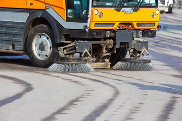 special vehicle for cleaning the road from dirt brushes the city street. road industry service