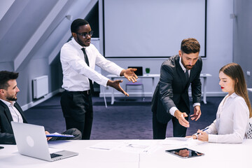 Diverse black employee and white boss arguing in office, african worker disagreeing with dismissal...