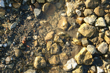 Mountain stream flowing over the stones. Crystal clear water.