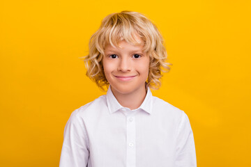 Photo of cheerful positive blond schoolboy smile wear school uniform isolated yellow color background