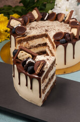 the cut cake is decorated with milk chocolate cubes and berries