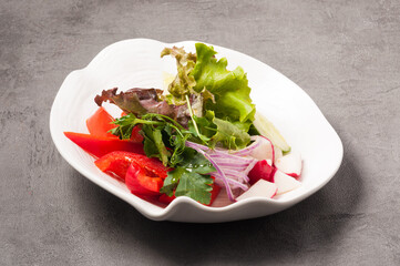 salad of fresh vegetables: cucumbers, tomatoes, radishes, peppers