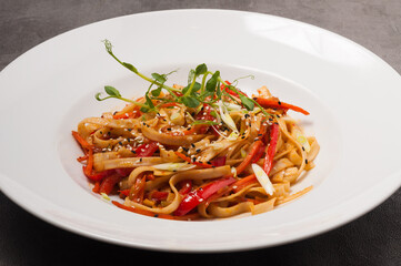 udon wheat noodles with vegetables sesame seeds and microgreens