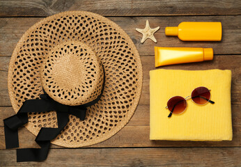 Flat lay composition with beach accessories on wooden background