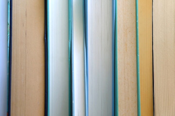 Stack of books with blue and green covers. Selective focus.