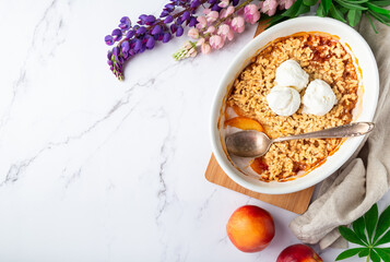 Homemade nectarine crumble with vanilla ice cream