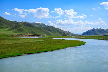 Grassland and river with mountain natural landscape in Xinjiang.