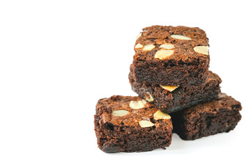 pieces of fresh homemade chocolate brownie, square shape, with sliced almond on top isolated on white background