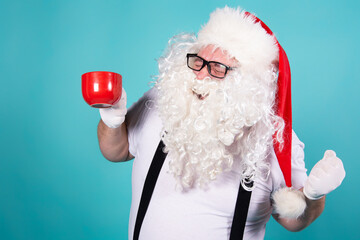 Funny Santa Claus is drinking hot coffee.