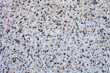 Abstract background decorative mosaic plaster. Stucco backdrop with rocks crumbs, , finishing texture