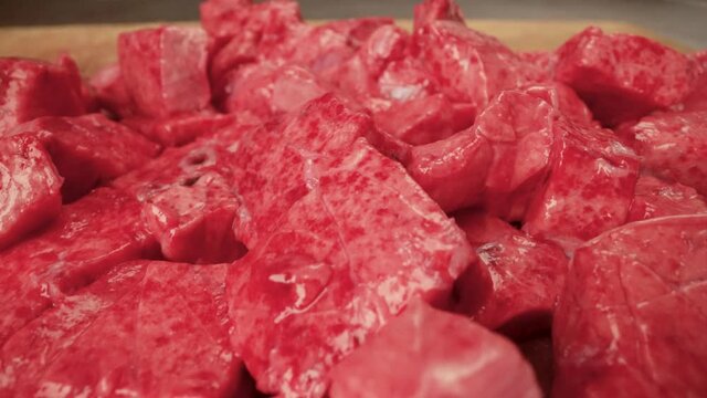 Chef Neatly Chopping Meat. The chef cuts the meat, beef close-up.