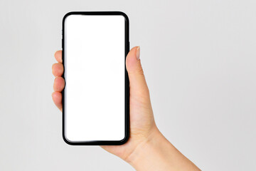 Hand holding black smartphone isolated on white background, clipping path. Woman hand using smartphone with blank screen.